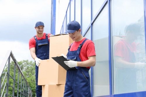 Professional removals team handling packed boxes in Earlscourt