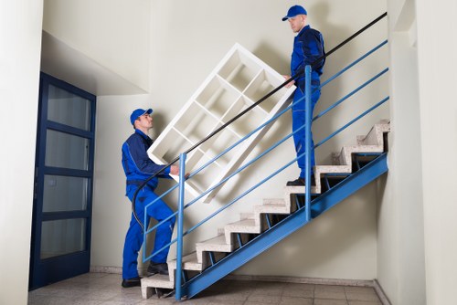 Staff using correct lifting techniques during a home move