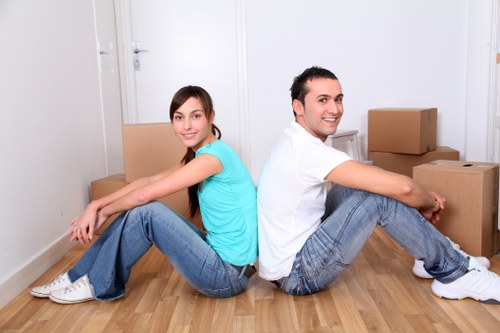 Van removal team handling furniture in Earlscourt street access